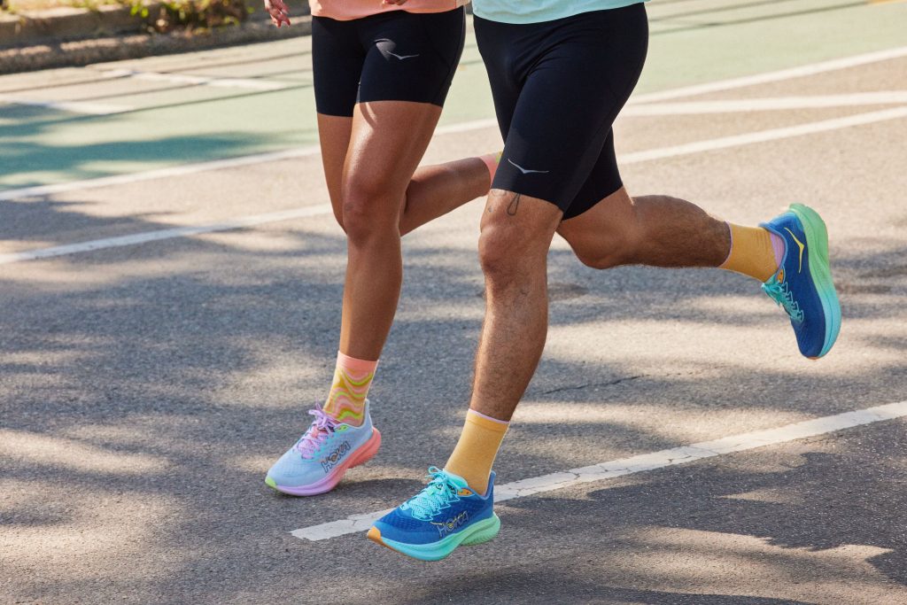 man and woman running on the road