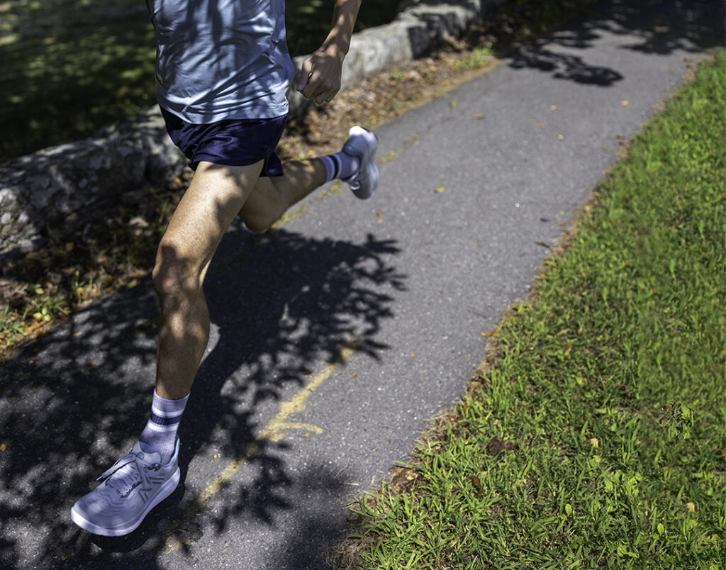 Man running in Karhu Ikoni 3.0 in park