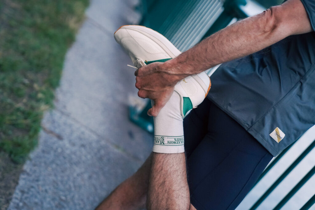 Person stretching in the tracksmith eliot ryder